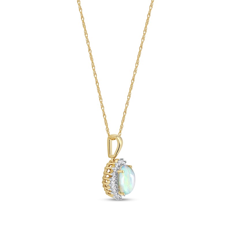 Oval Opal and 1/8 CT. T.W. Baguette and Round Diamond Starburst Frame Pendant in 10K Gold