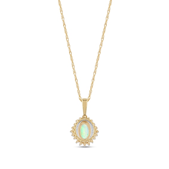 Oval Opal and 1/8 CT. T.w. Baguette and Round Diamond Starburst Frame Pendant in 10K Gold