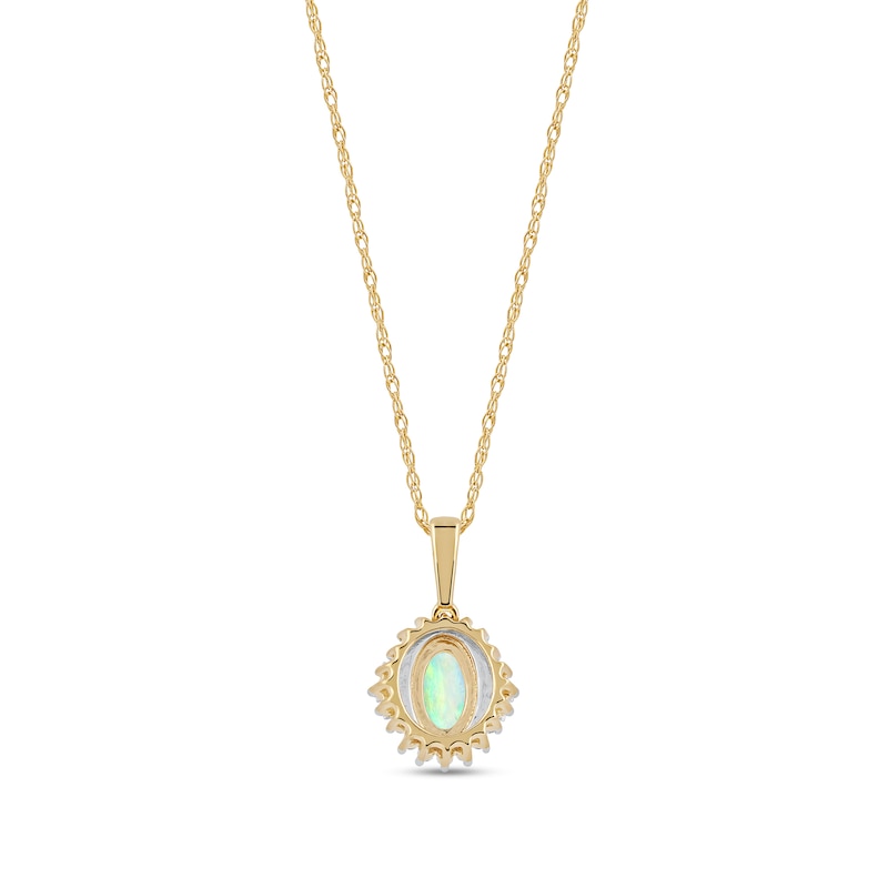 Oval Opal and 1/8 CT. T.W. Baguette and Round Diamond Starburst Frame Pendant in 10K Gold