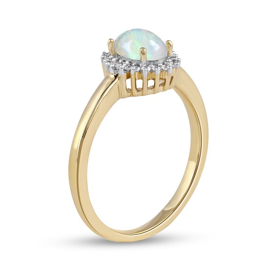 Oval Opal and 1/8 CT. T.w. Baguette and Round Diamond Starburst Frame Ring in 10K Gold