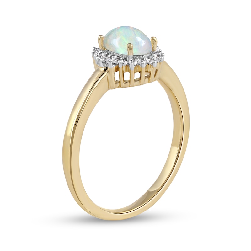 Main Image 2 of Oval Opal and 1/8 CT. T.W. Baguette and Round Diamond Starburst Frame Ring in 10K Gold