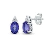 Thumbnail Image 0 of Oval Tanzanite and 1/20 CT. T.W. Diamond Tri-Top Stud Earrings in 10K White Gold