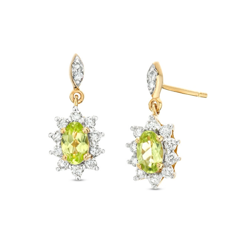Main Image 1 of Oval Peridot and 1/4 CT. T.W. Diamond Sunburst Frame Dangle Drop Earrings in 10K Gold