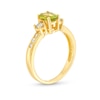 Thumbnail Image 1 of Oval Peridot and 1/4 CT. T.W. Diamond Three Stone Ring in 14K Gold