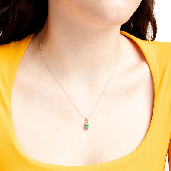 Oval Emerald and 1/15 CT. T.w. Diamond Rectangle Frame Pendant in 10K Gold