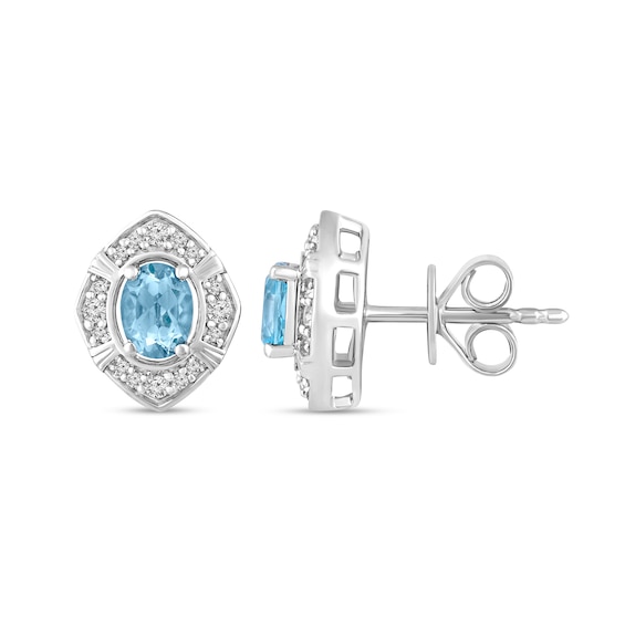 Oval Sky Blue Topaz and 1/8 CT. T.w. Diamond Tilted Frame Stud Earrings in 10K White Gold