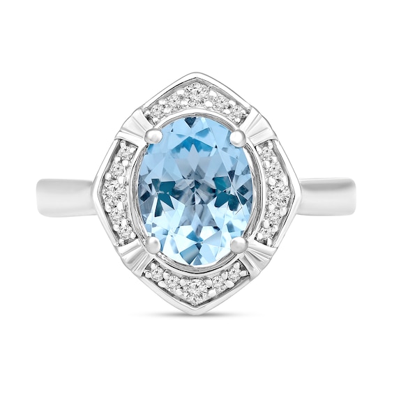 Oval Sky Blue Topaz and 1/8 CT. T.w. Diamond Tilted Frame Ring in 10K White Gold