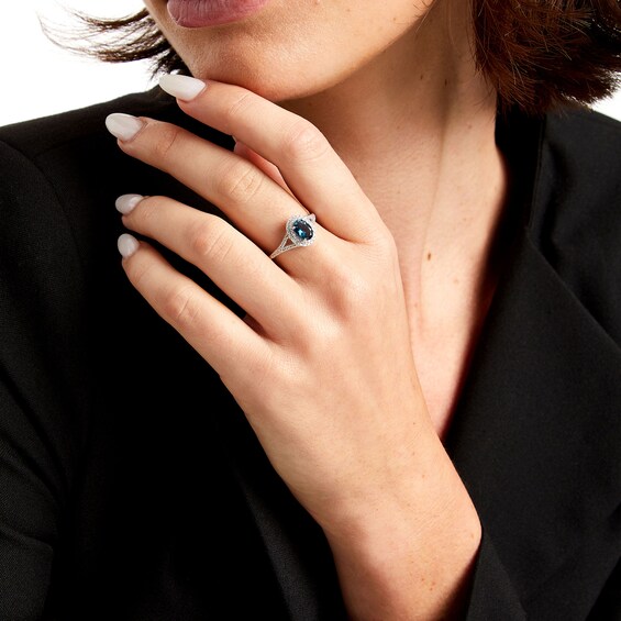 Oval London Blue Topaz and 1/6 CT. T.w. Diamond Framed Ring in 10K White Gold