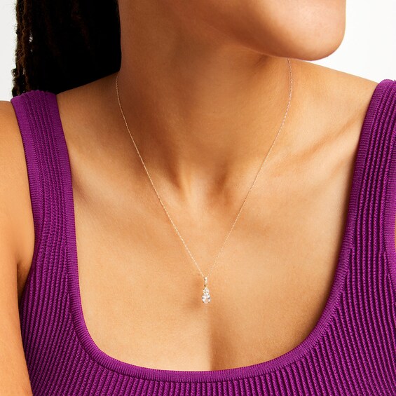 Oval White Lab-Created Sapphire and 1/15 CT. T.w. Diamond Pendant in 10K Gold