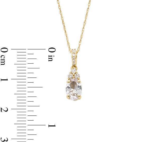 Oval White Lab-Created Sapphire and 1/15 CT. T.w. Diamond Pendant in 10K Gold