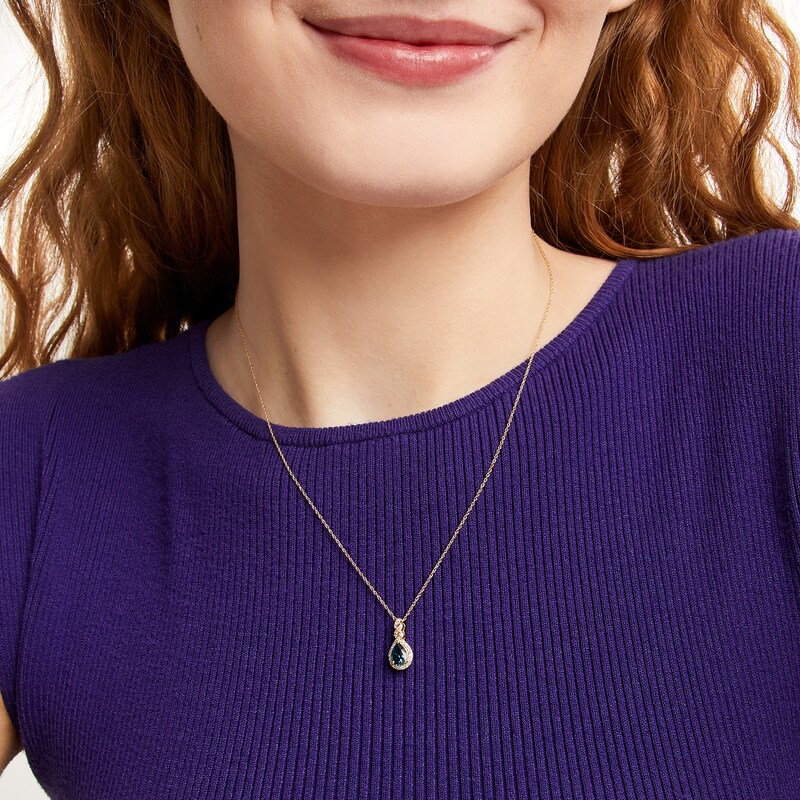 Main Image 2 of Pear-Shaped London Blue Topaz and 1/8 CT. T.W. Diamond Frame Twist Pendant in 10K Gold