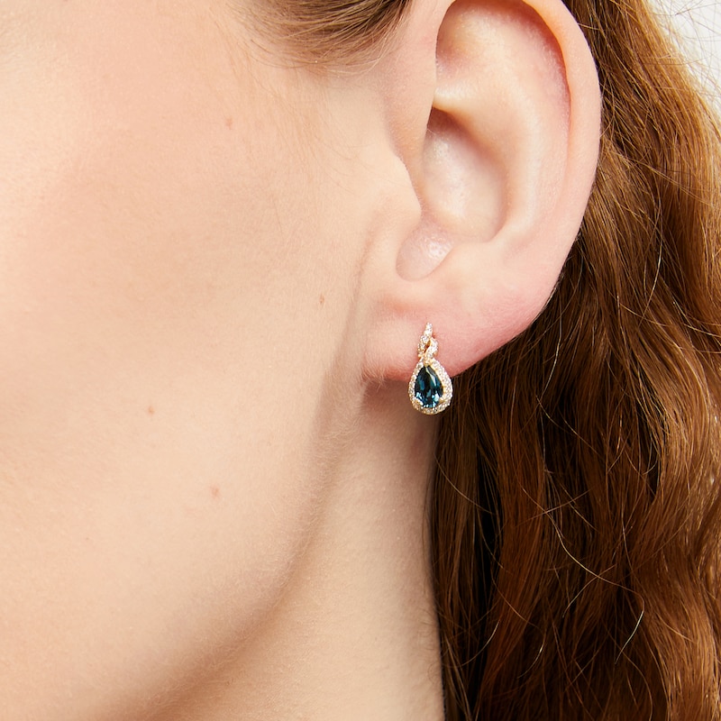 Main Image 2 of Pear-Shaped London Blue Topaz and 1/6 CT. T.W. Diamond Frame Twist Stud Earrings in 10K Gold
