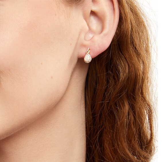 Pear-Shaped Lab-Created Opal and 1/6 CT. T.w. Diamond Frame Twist Stud Earrings in 10K Gold