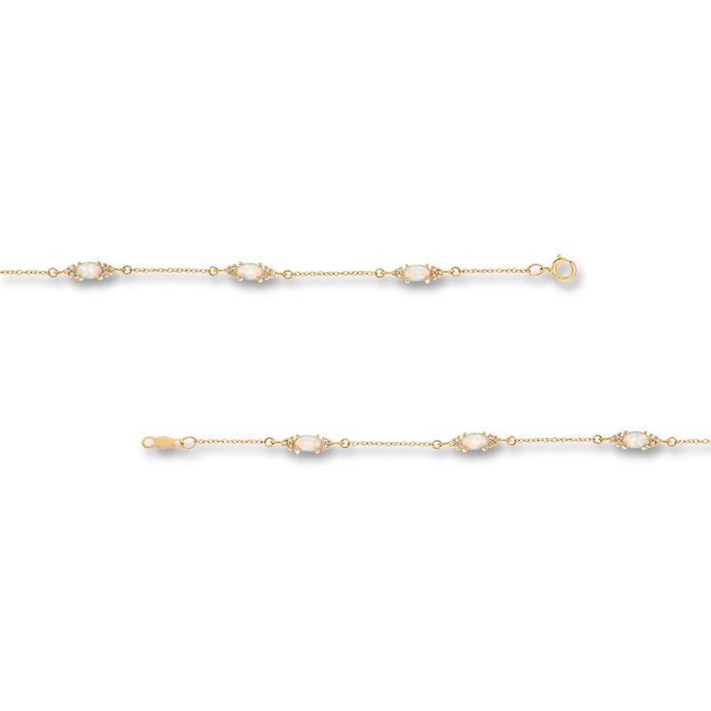 Oval Lab-Created Opal and 1/15 CT. T.W. Diamond Three Stone Station Bracelet in 10K Gold - 7.25"