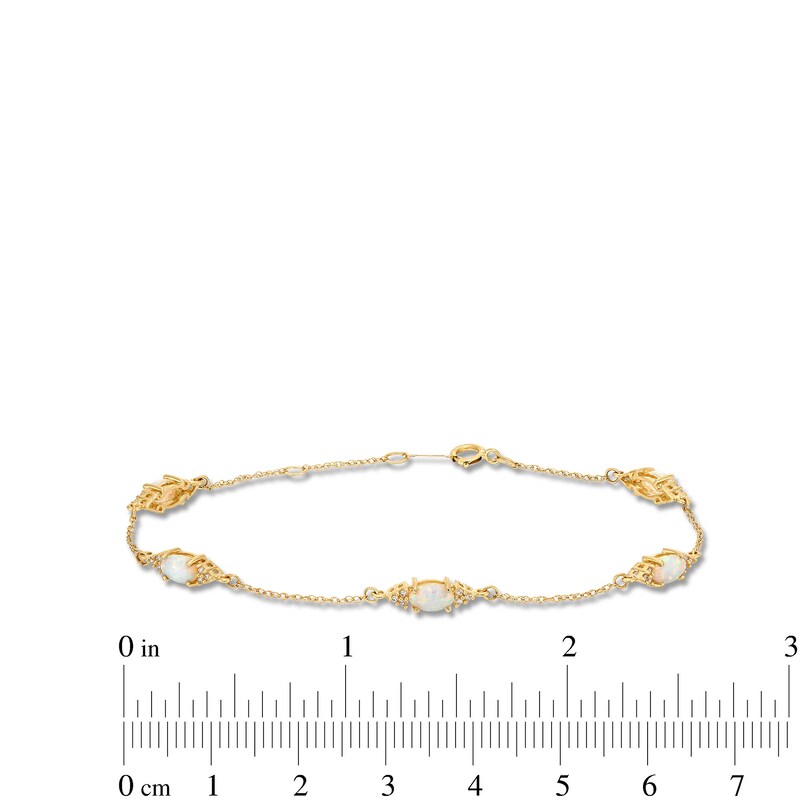 Main Image 4 of Oval Lab-Created Opal and 1/15 CT. T.W. Diamond Three Stone Station Bracelet in 10K Gold - 7.25"