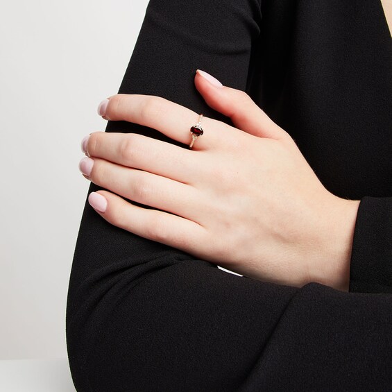 Oval Garnet and 1/10 CT. T.w. Diamond Ring in 10K Gold