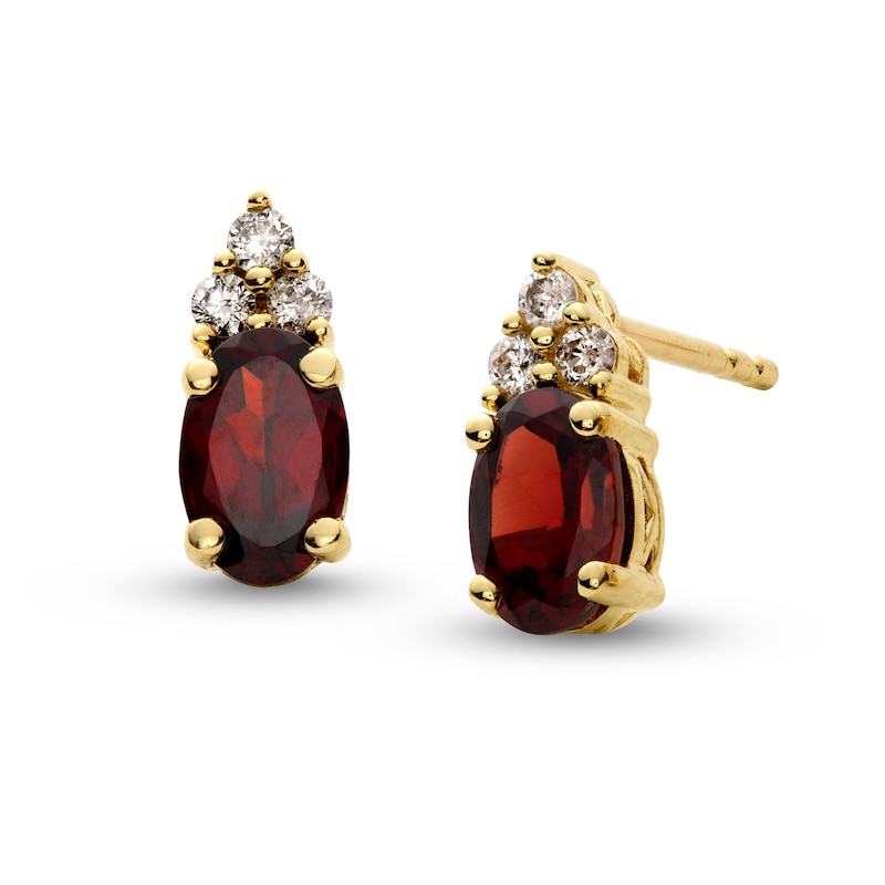 Main Image 1 of Oval Garnet and 1/10 CT. T.W. Diamond Stud Earrings in 10K Gold