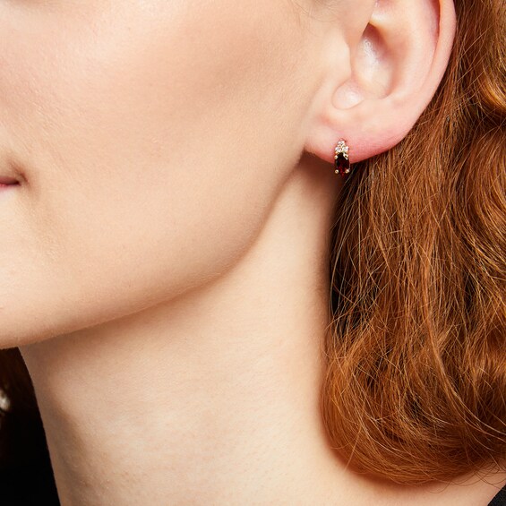 Oval Garnet and 1/10 CT. T.w. Diamond Stud Earrings in 10K Gold