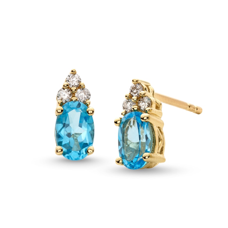 Main Image 1 of Oval Swiss Blue Topaz and 1/10 CT. T.W. Diamond Stud Earrings in 10K Gold