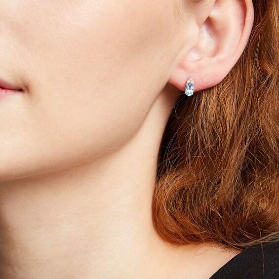 Oval Swiss Blue Topaz and 1/10 CT. T.w. Diamond Stud Earrings in 10K Gold