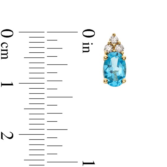 Oval Swiss Blue Topaz and 1/10 CT. T.w. Diamond Stud Earrings in 10K Gold