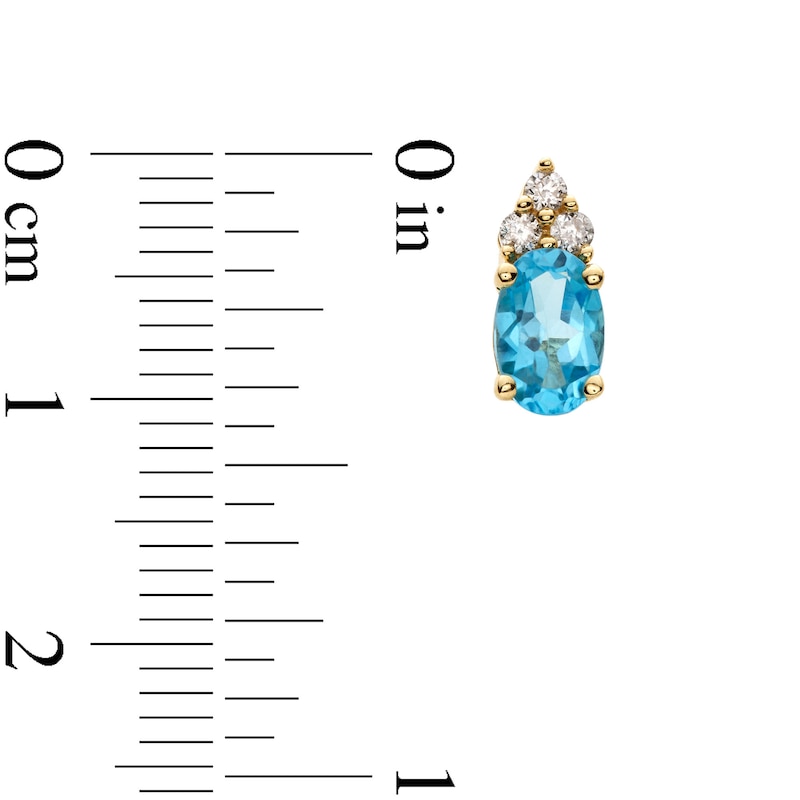 Main Image 3 of Oval Swiss Blue Topaz and 1/10 CT. T.W. Diamond Stud Earrings in 10K Gold