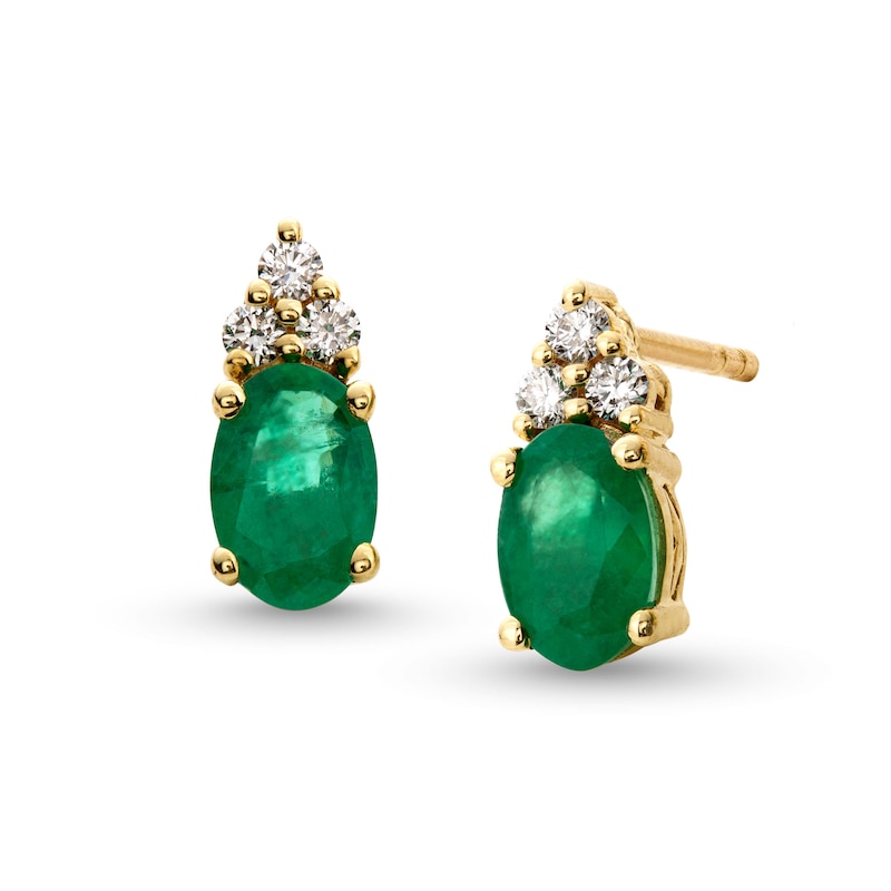 Main Image 1 of Oval Emerald and 1/10 CT. T.W. Diamond Stud Earrings in 10K Gold