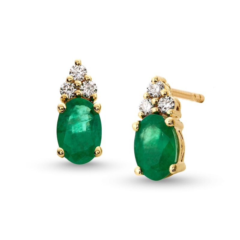 Oval Emerald and 1/10 CT. T.W. Diamond Stud Earrings in 10K Gold