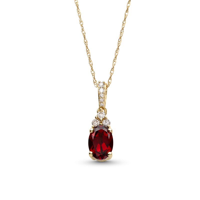 Main Image 1 of Oval Garnet and 1/15 CT. T.W. Diamond Pendant in 10K Gold