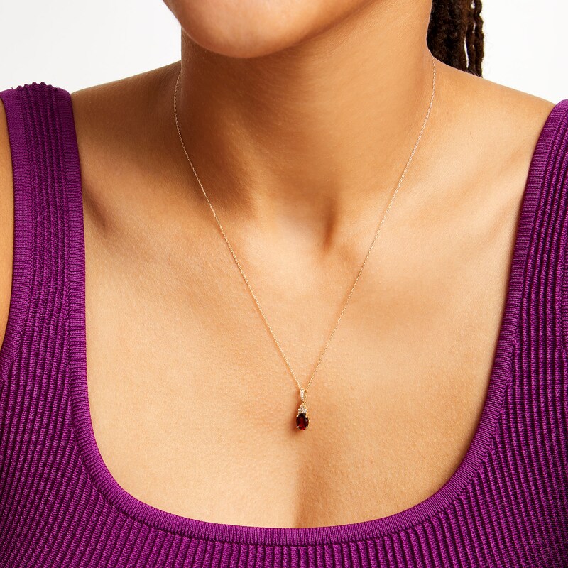 Main Image 2 of Oval Garnet and 1/15 CT. T.W. Diamond Pendant in 10K Gold