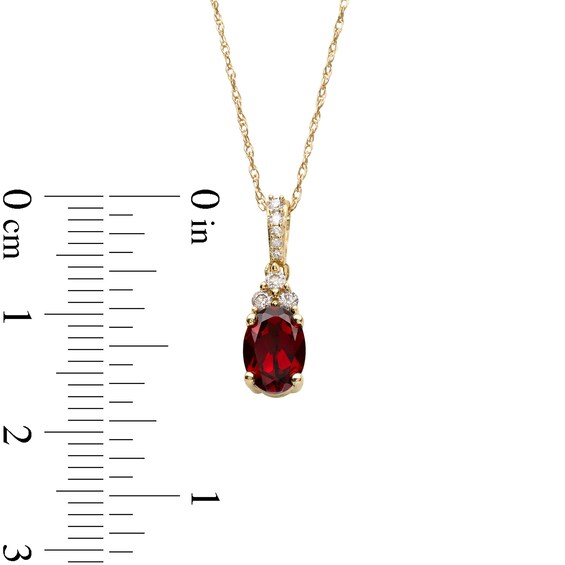 Oval Garnet and 1/15 CT. T.w. Diamond Pendant in 10K Gold