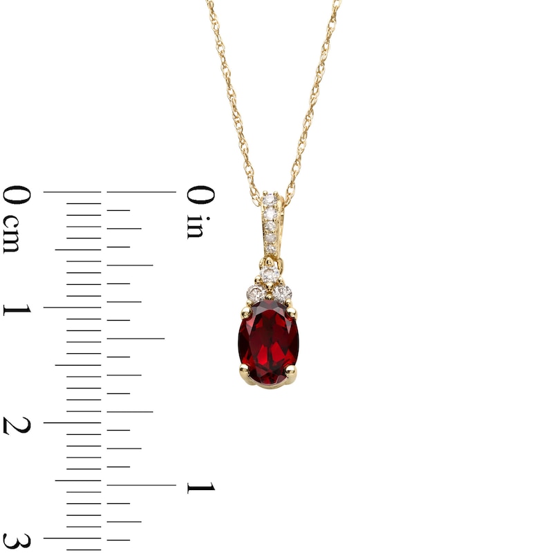 Main Image 3 of Oval Garnet and 1/15 CT. T.W. Diamond Pendant in 10K Gold