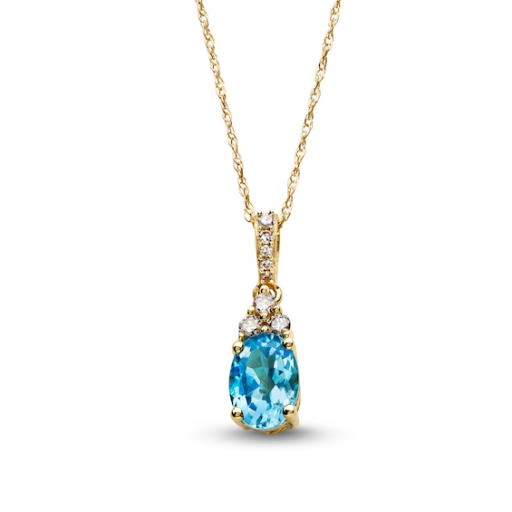 Oval Swiss Blue Topaz and 1/15 CT. T.w. Diamond Pendant in 10K Gold