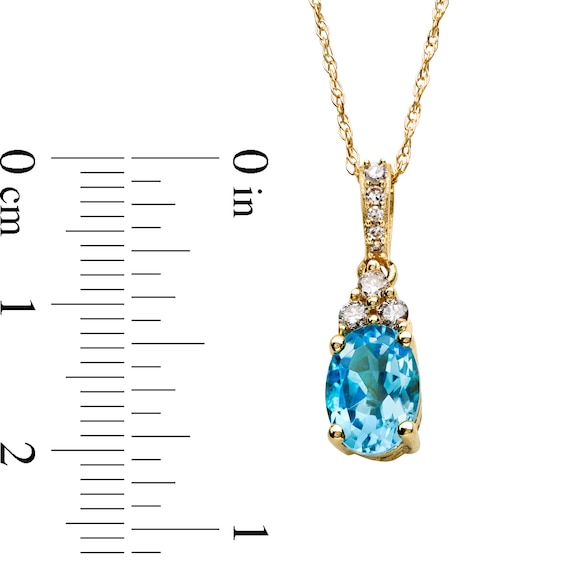 Oval Swiss Blue Topaz and 1/15 CT. T.w. Diamond Pendant in 10K Gold