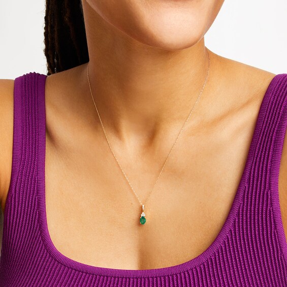 Oval Emerald and 1/15 CT. T.w. Diamond Pendant in 10K Gold