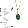 Thumbnail Image 2 of Oval Emerald and 1/15 CT. T.W. Diamond Pendant in 10K Gold