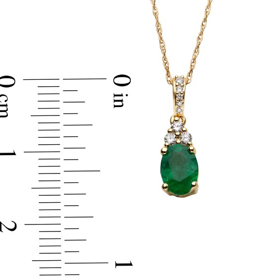 Oval Emerald and 1/15 CT. T.w. Diamond Pendant in 10K Gold