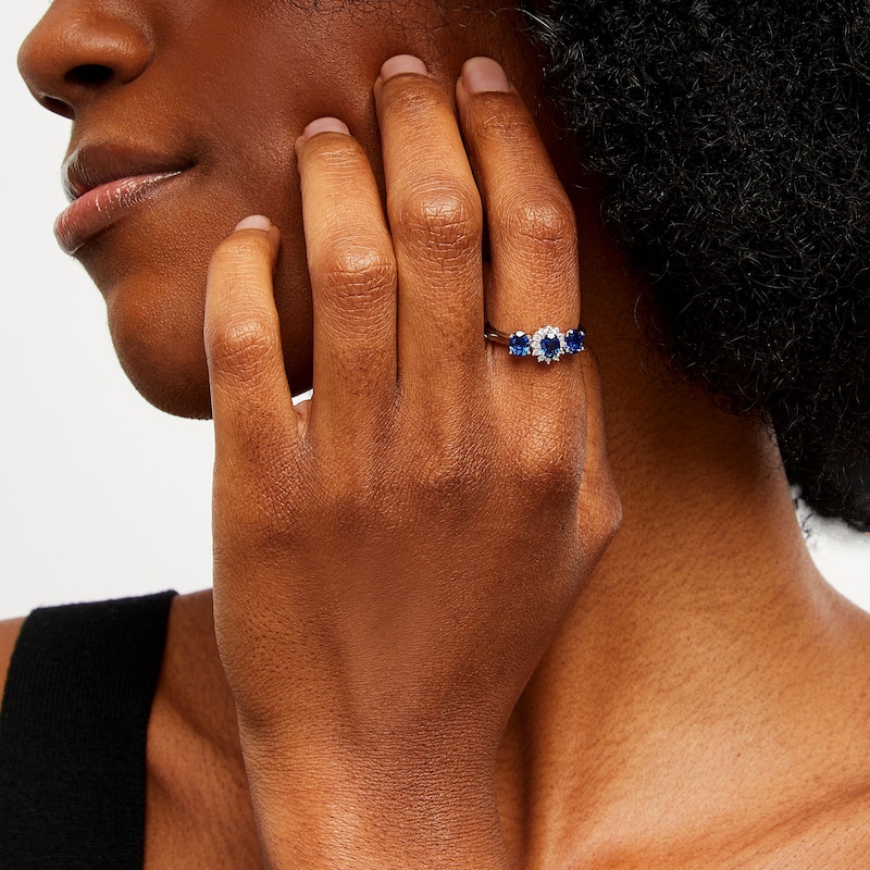 Main Image 2 of Oval Blue Lab-Created Sapphire and 1/8 CT. T.W. Diamond Starburst Frame Three Stone Ring in 10K White Gold