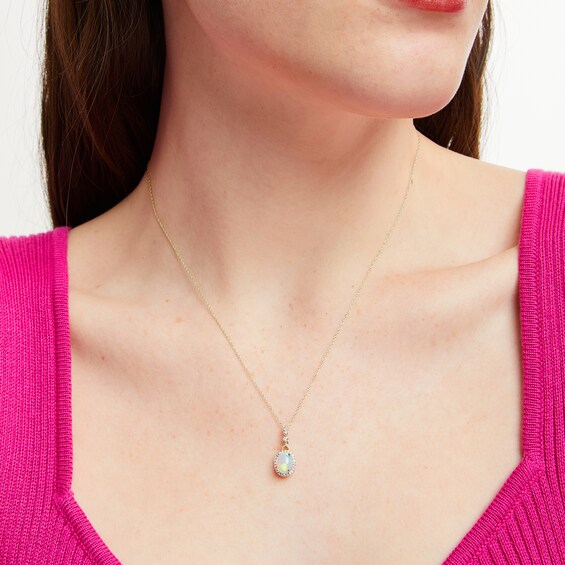 Oval Opal and 1/10 CT. T.w. Diamond Frame Drop Pendant in 10K Gold