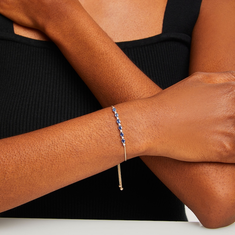 Main Image 2 of Oval Blue Sapphire and 1/8 CT. T.W. Diamond Alternating Bolo Bracelet in 10K Gold - 9"