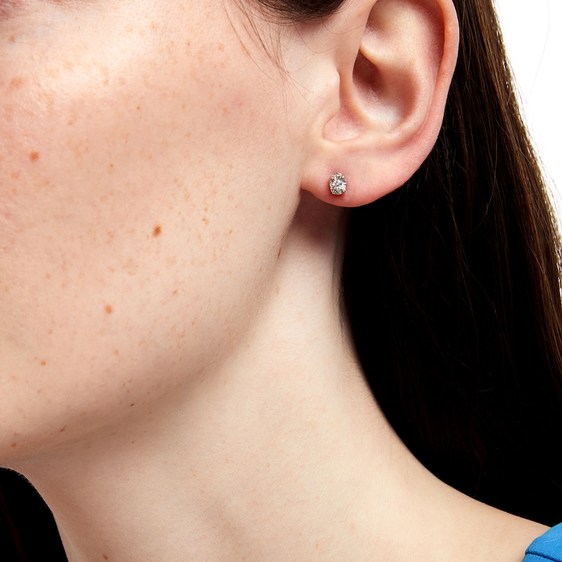 Main Image 2 of 1/8 CT. T.W. Diamond Solitaire Oval Stud Earrings in 10K White Gold