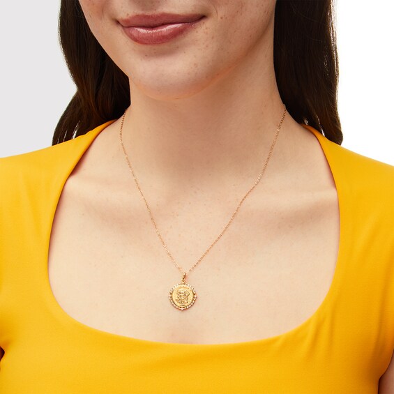 1/10 CT. T.w. Diamond Scallop Frame Jesus Medallion Pendant in 10K Gold