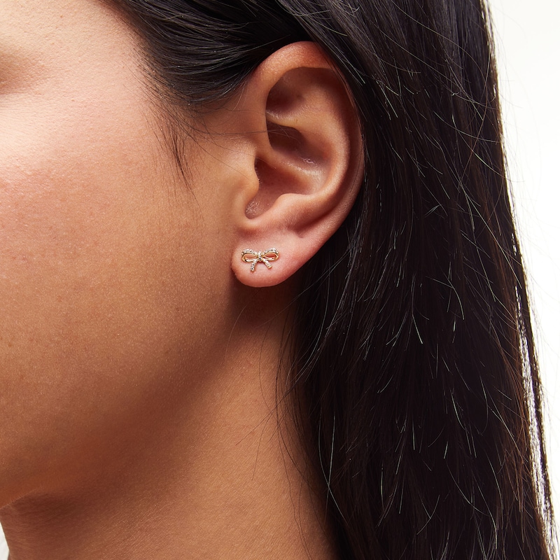 Main Image 2 of 1/10 CT. T.W. Diamond Bow Stud Earrings in 10K Gold