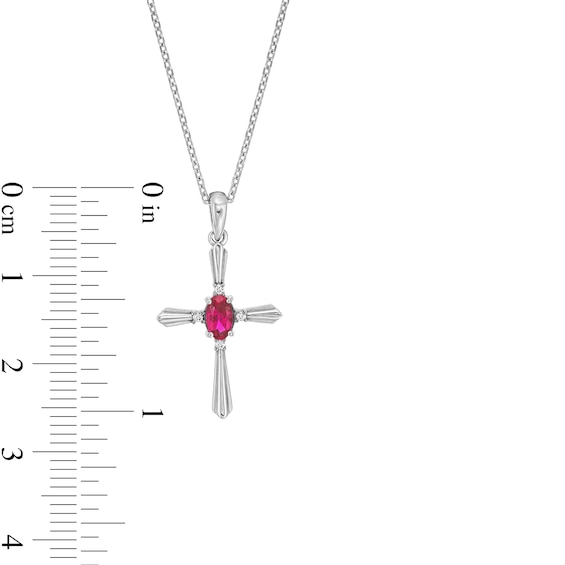 Oval Lab-Created Ruby and Diamond Accent Flared Cross Pendant in Sterling Silver