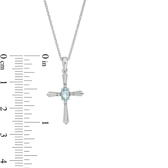 Oval Simulated Aquamarine and Diamond Accent Flared Cross Pendant in Sterling Silver