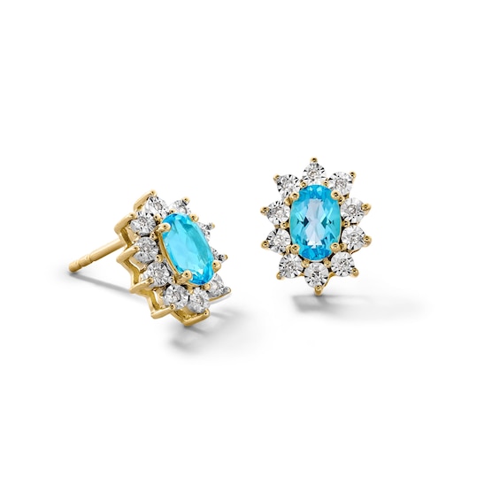 Oval Swiss Blue Topaz and 1/20 CT. T.w. Diamond Sunburst Frame Stud Earrings in 10K Gold
