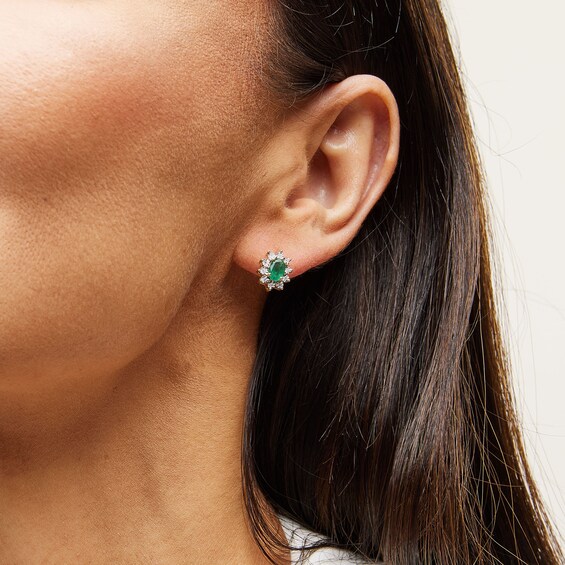 Oval Emerald and 1/20 CT. T.w. Diamond Sunburst Frame Stud Earrings in 10K Gold
