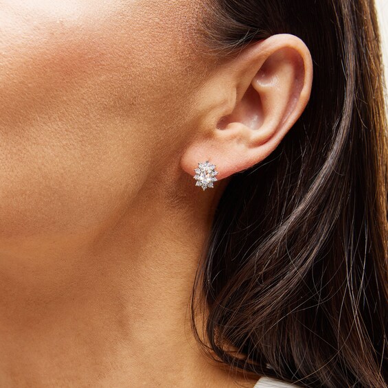 Oval White Lab-Created Sapphire and 1/20 CT. T.w. Diamond Sunburst Frame Stud Earrings in 10K Gold