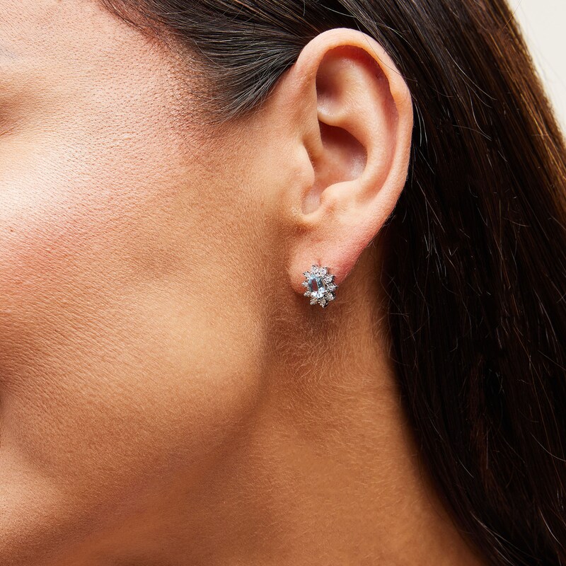 Main Image 2 of Oval Aquamarine and 1/20 CT. T.W. Diamond Sunburst Frame Stud Earrings in 10K White Gold