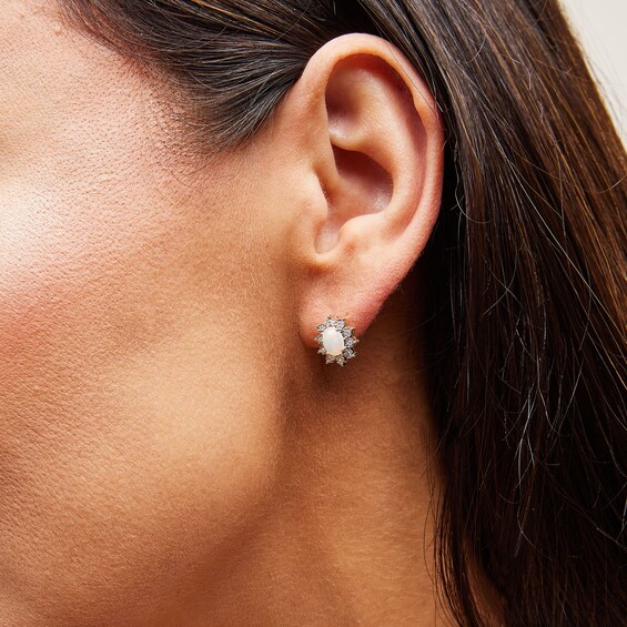 Oval Opal and 1/20 CT. T.w. Diamond Sunburst Frame Stud Earrings in 10K Gold